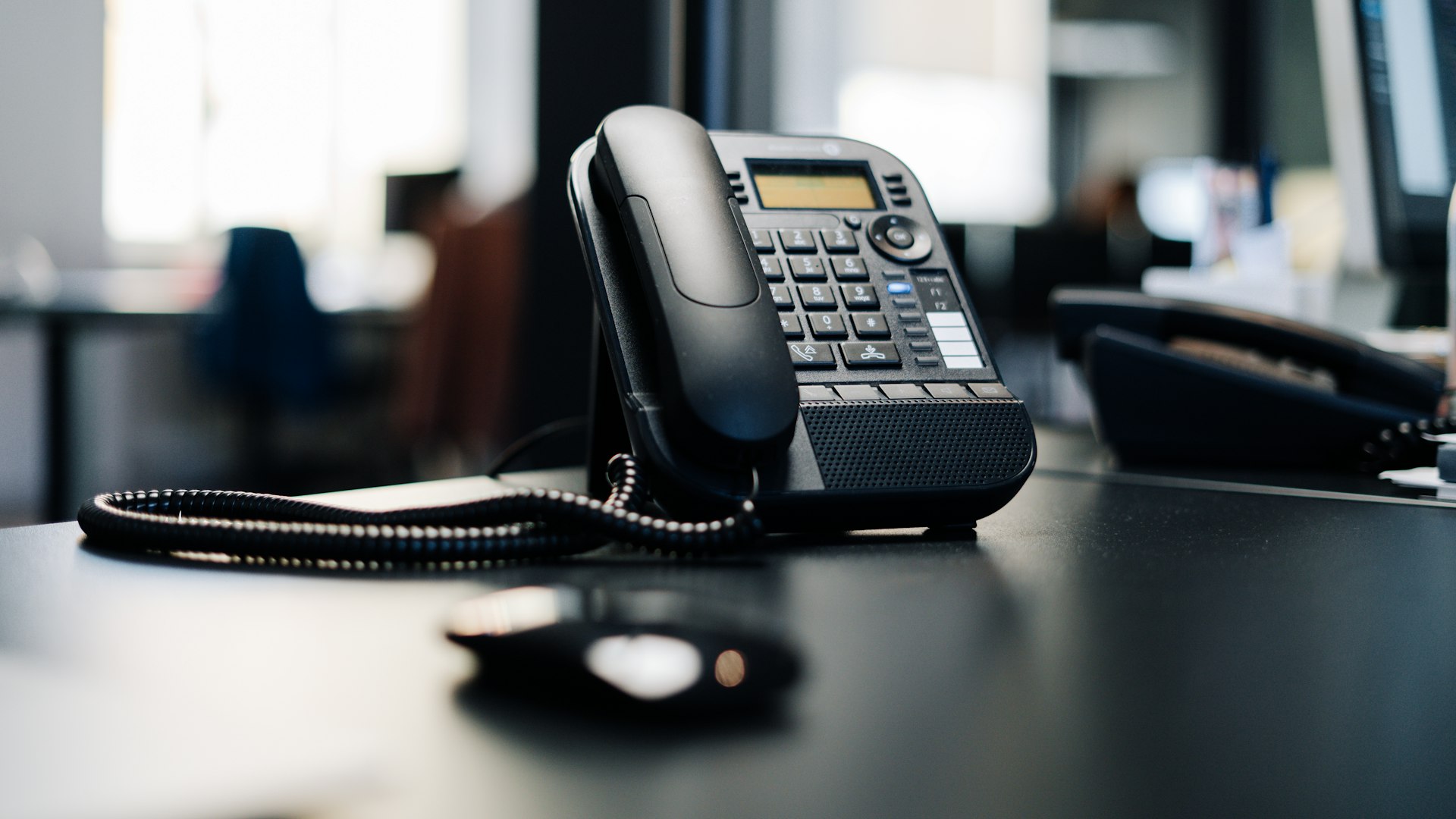 Telefon biurowy na biurku — skontaktuj się z Lechtom telefonicznie
